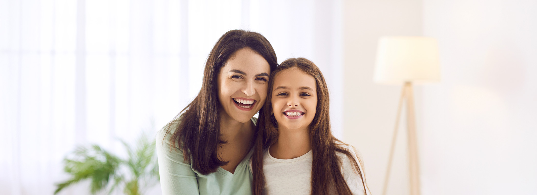 Mother and daughter sitting on the couch